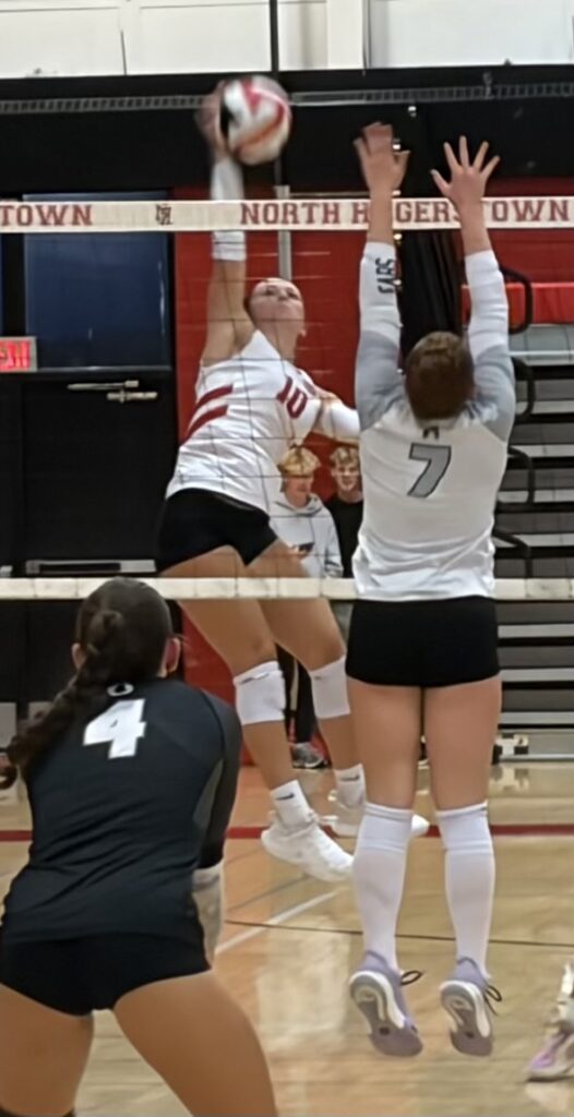 North Hagerstown's Lily Hajel (10) tees up a kill attempt over the defense of Oakdale's Layla Ladd (7).
