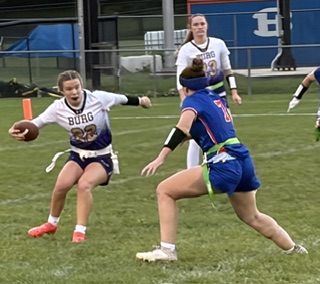 Smithsburg quarterback Rileigh Romberger (22) takes a stutter step in an attempt to elude Boonsboro's Raley Haller (7).