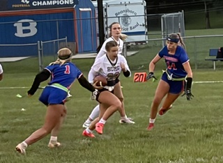 Smithsburg quarterback Rileigh Romberger splits the gap between Boonsboro's Brennyn Cronise (1) and Sarah Moler (14).